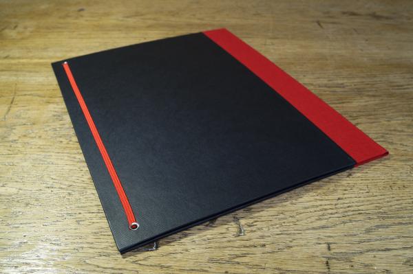 Black binder, red linen, elastic strap